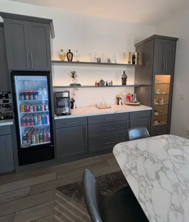 Grey beverage center with a glass-door fridge and open shelves