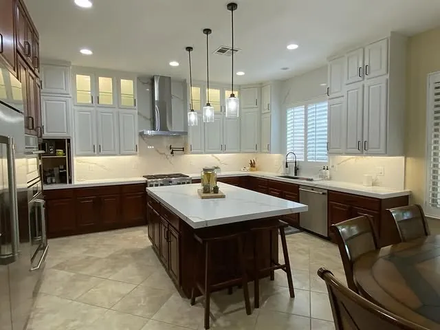 Henderson kitchen with glass-front uppers lit at the top of a 10-foot ceiling