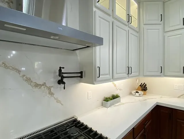Pot filler and marbled quartz backsplash in a Henderson kitchen