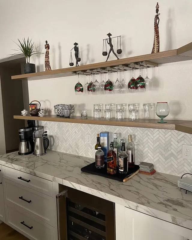 Coffee bar with solid oak floating shelves and hanging wine glasses