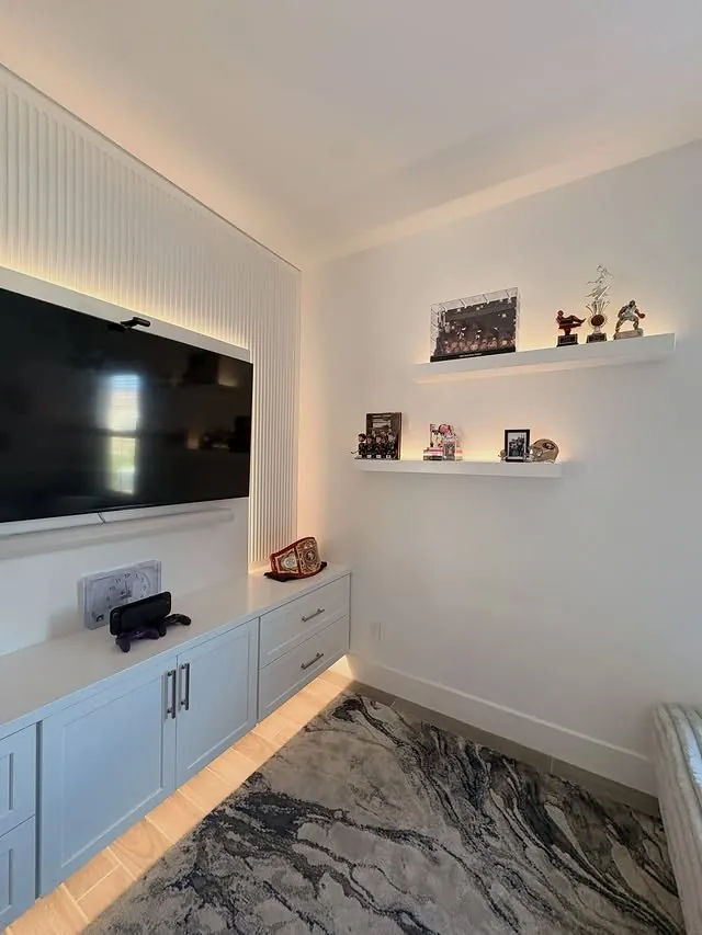 Collectible shelves beside the media wall