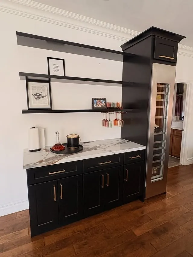 The bar's black base cabinets and open shelves from the front