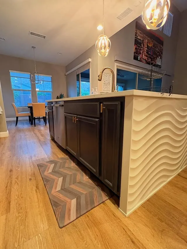 Curved island panels and a long rug toward the dining room