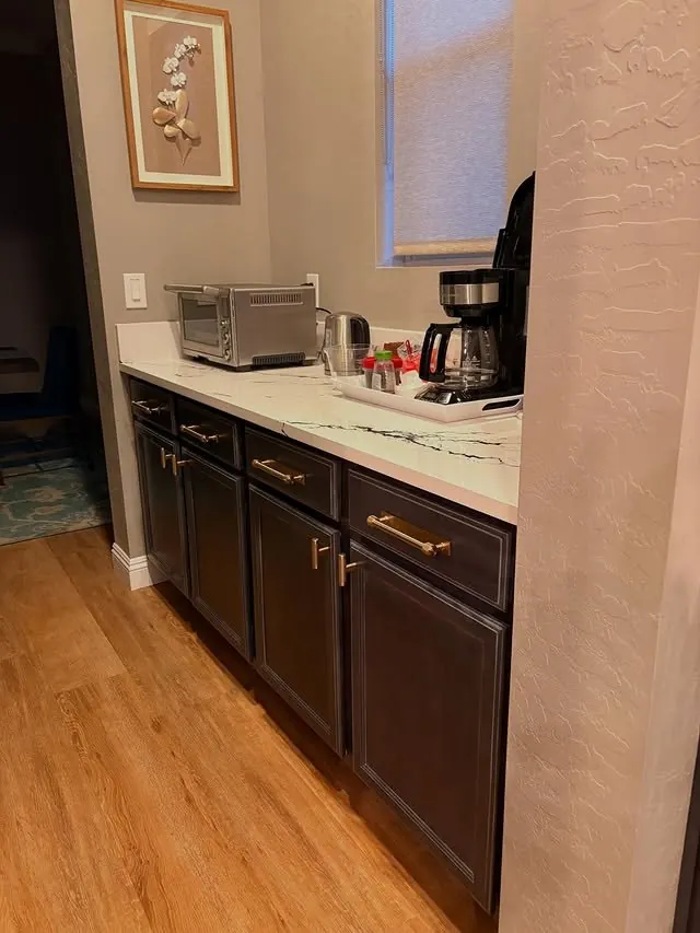 Coffee station with dark base cabinets and a quartz top