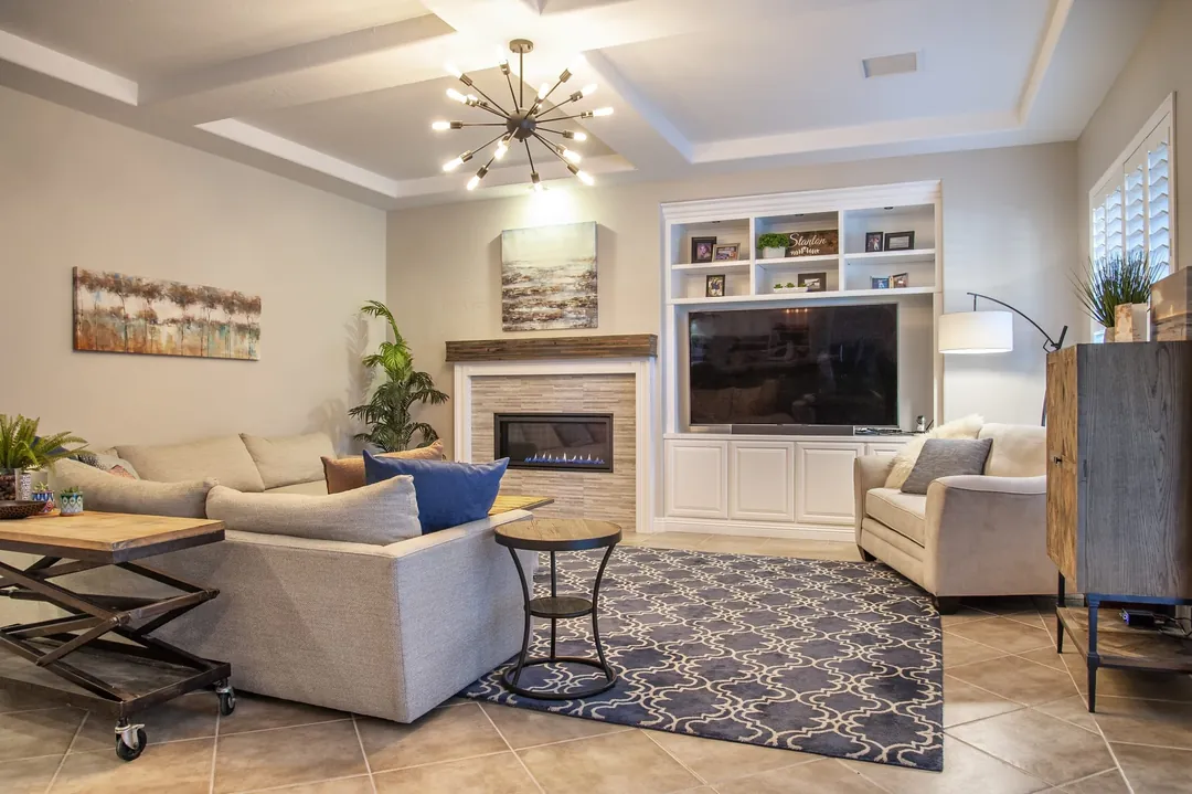 Family room with white built-in cabinetry around the TV and fireplace