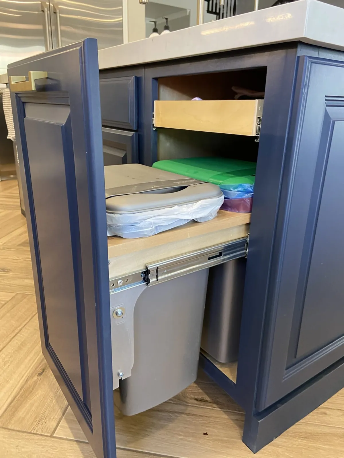 Navy cabinet with a pull-out for bins and containers